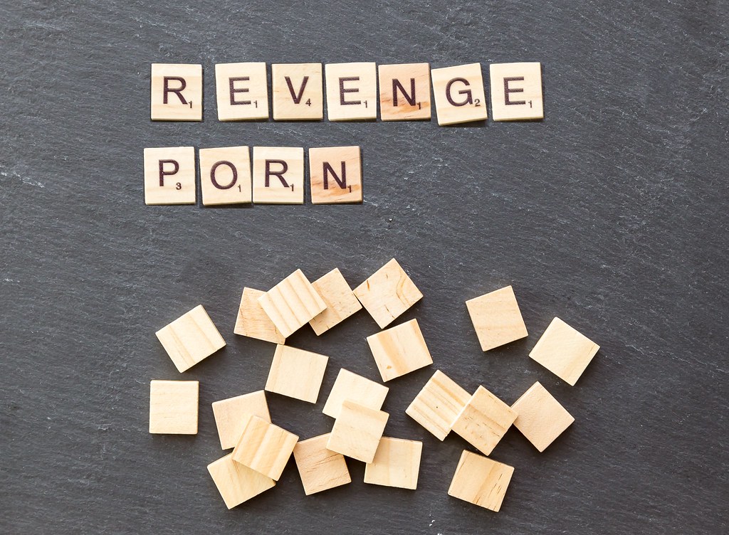 Tiles on a surface spelling out 'revenge porn'