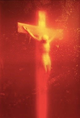 Chist on a cross is represented in a bright radiant light while the background fades into an intense red. The whole image appears as over-saturated