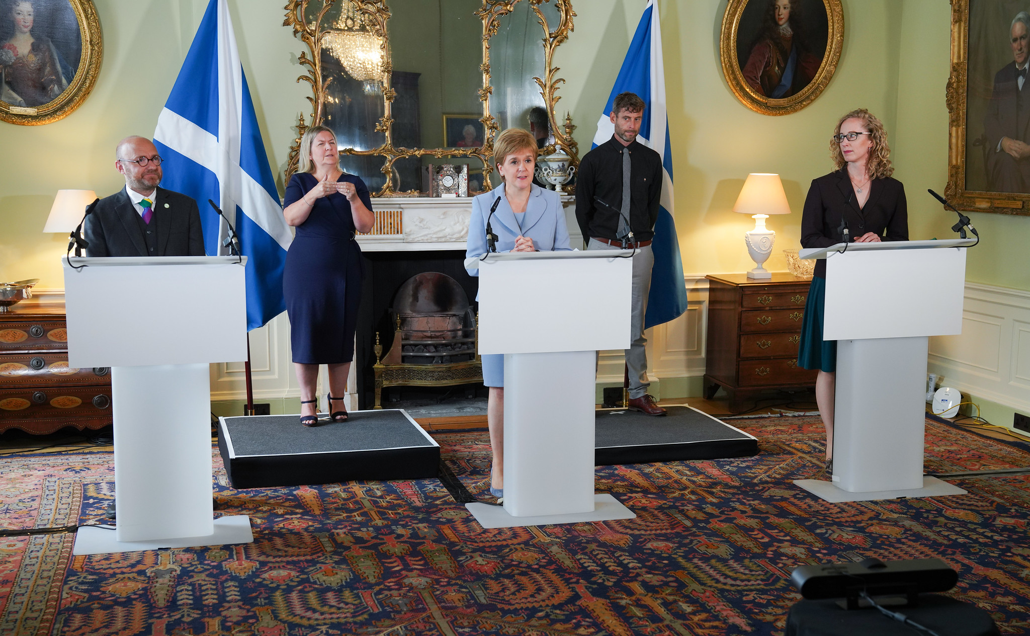 Patrick Harvie and Lorna Slater flank Nicola Sturgeon at a press conference in Bute House