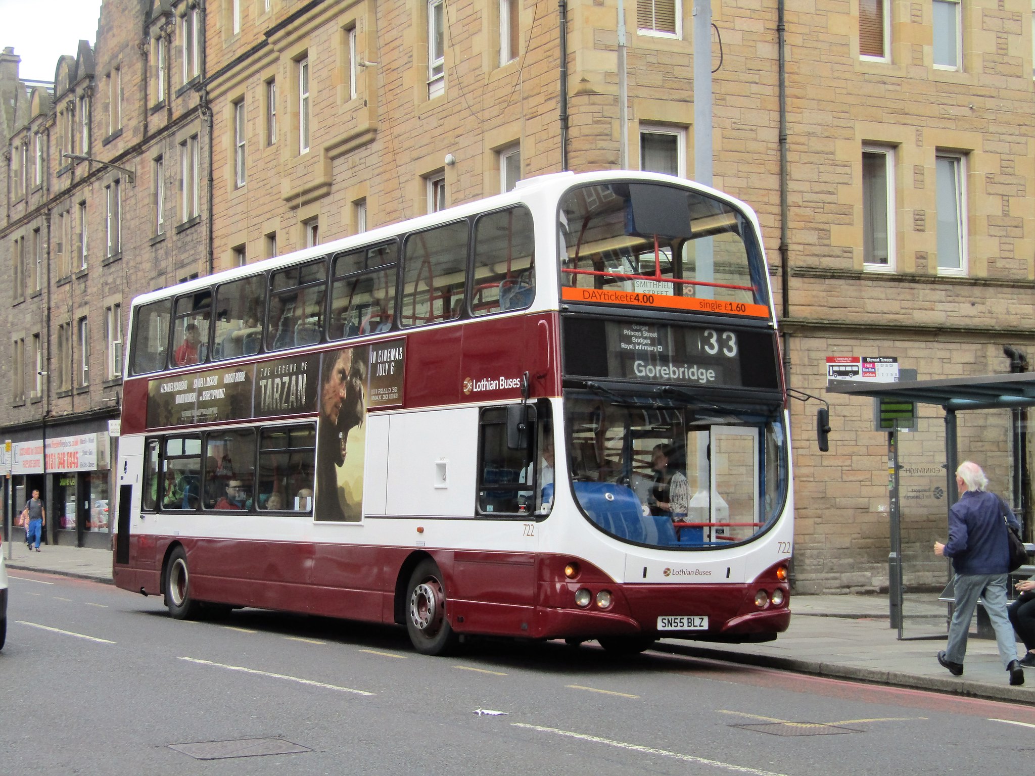 Double-decker Lothian bus waiting at bus stop for passengers to board.