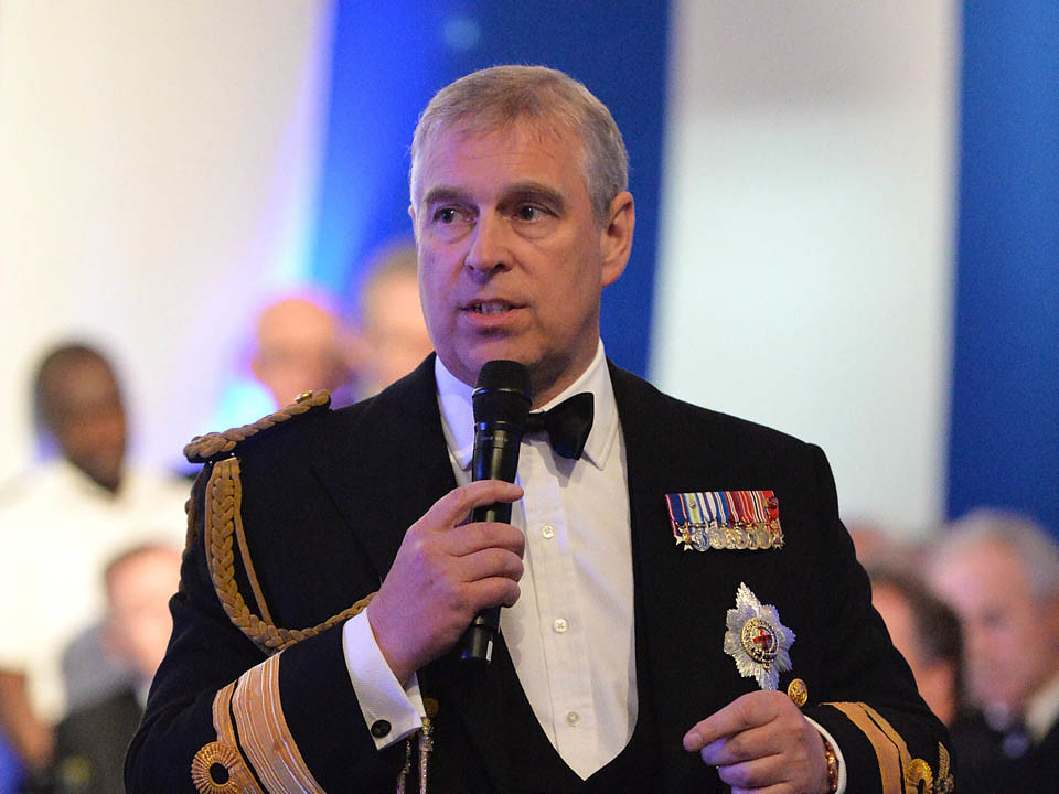 Prince andrew holding a microphone
