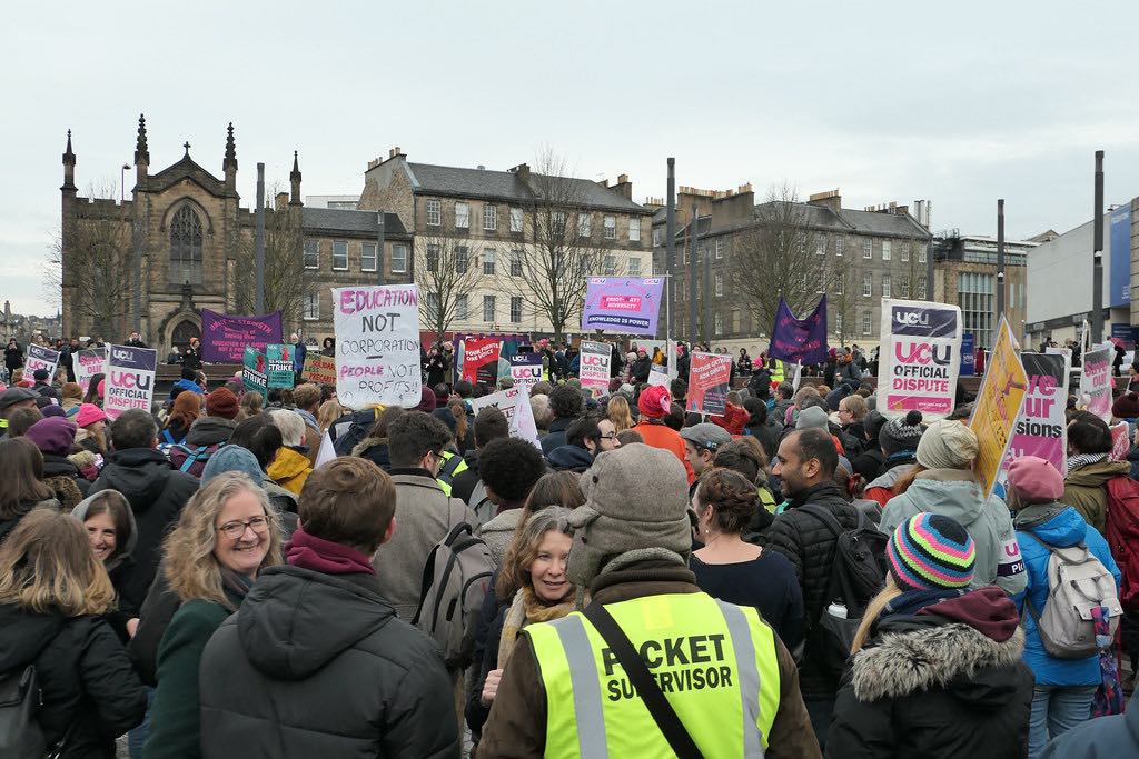 strikers with UCU banners gathered in a square