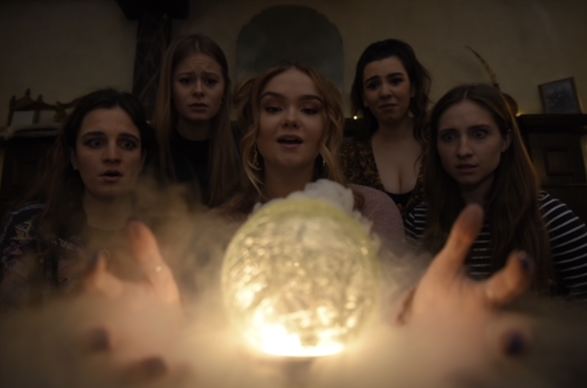 A group of teenagers hold a seance