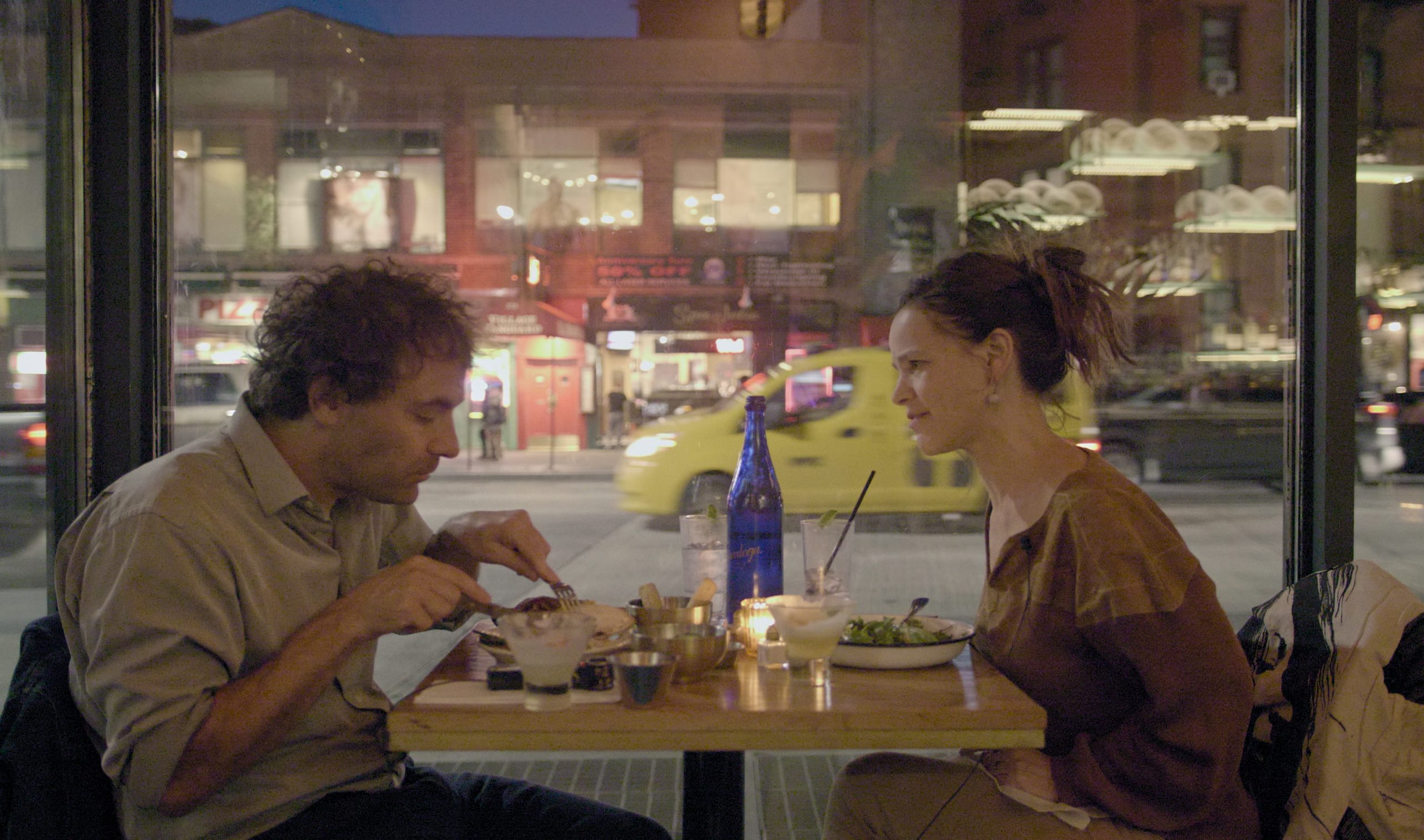 Still from Husband; the couple are eating at a restaurant