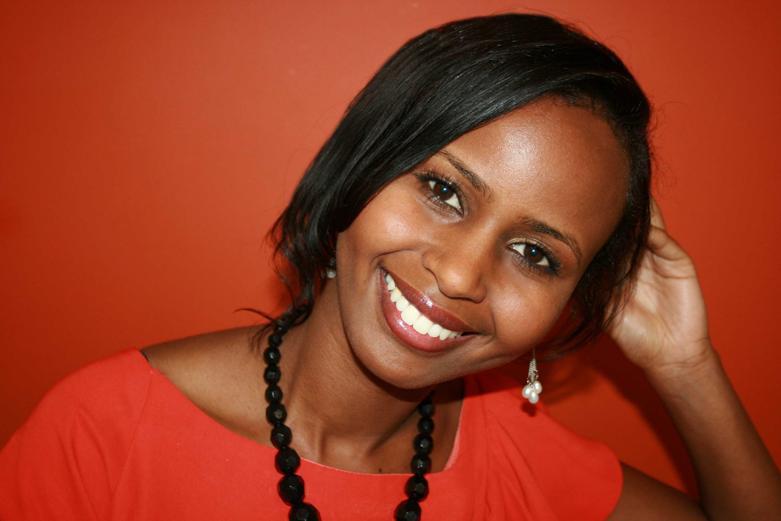 Portrait of Nadifa Mohamed smiling at the camera, looking relaxed.