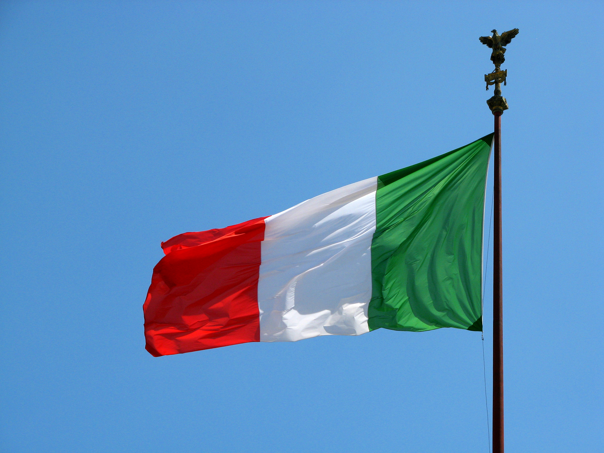 Italian Flag flying against a blue sky