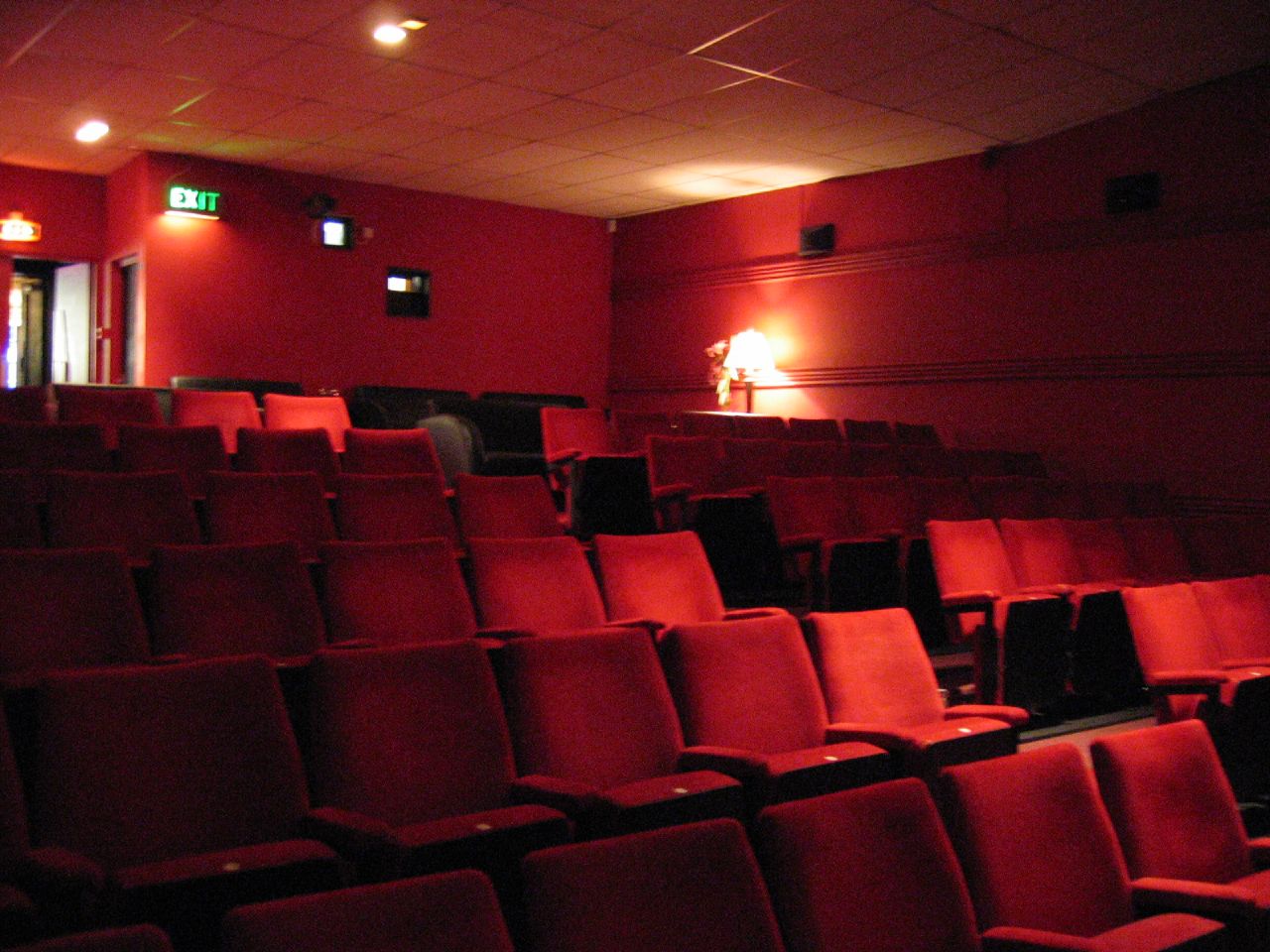 Rows of red velvet seats in a cinema