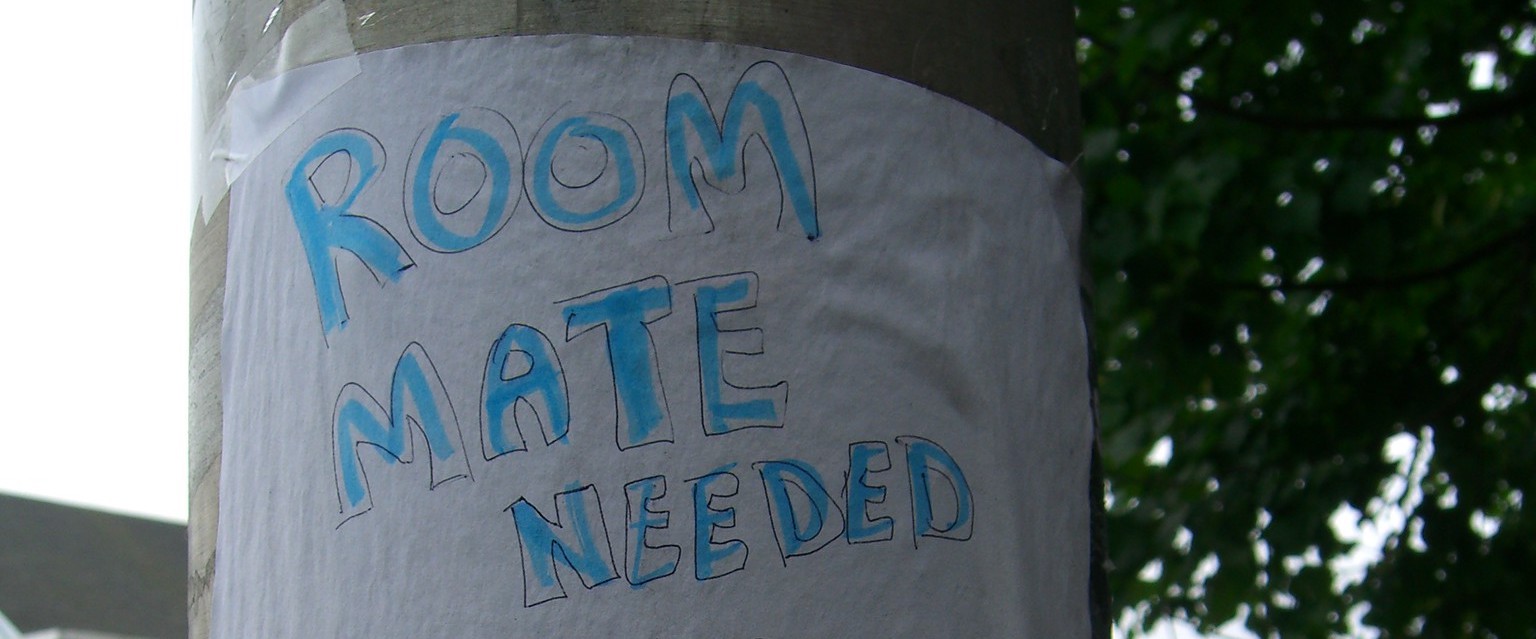 room mate needed sign on lamppost (words written in blue)