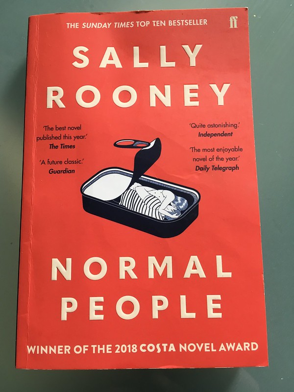 An image of the Normal People paperback, which is red and has an illustration of a sardine tin on the front cover