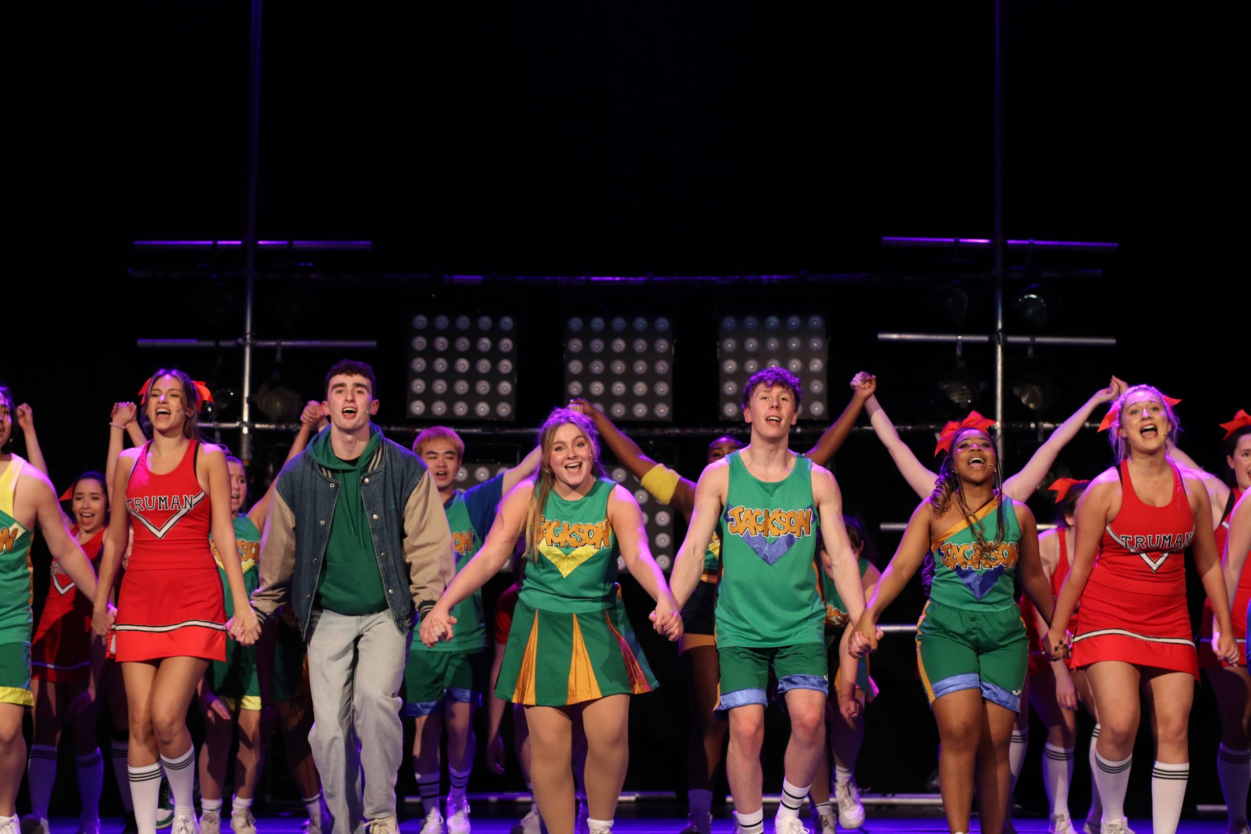 The cast of Bring it On doing a curtain bow on stage