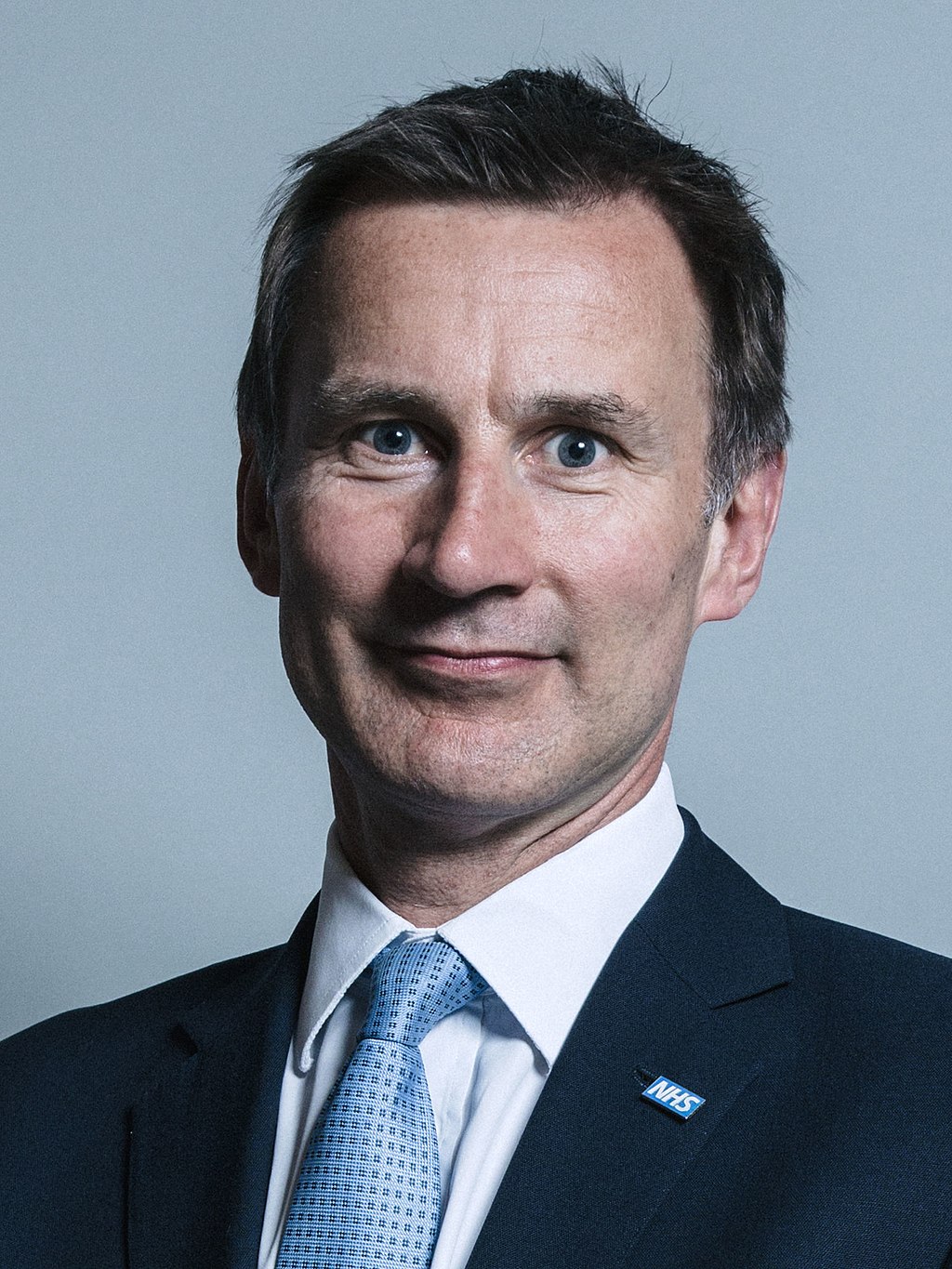 Image of Jeremy Hunt looking at the camera. He is wearing a white shirt, with a light blue tie and a dark colour blazer