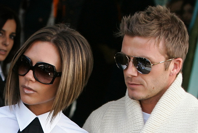 David and Victoria Beckham looking off camera towards the left, Victoria with a bob haircut