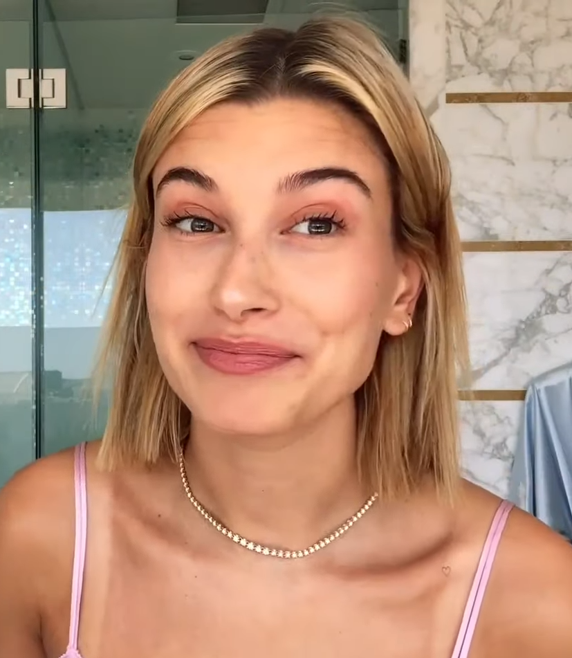 Hailey Bieber smiling at camera with no makeup on