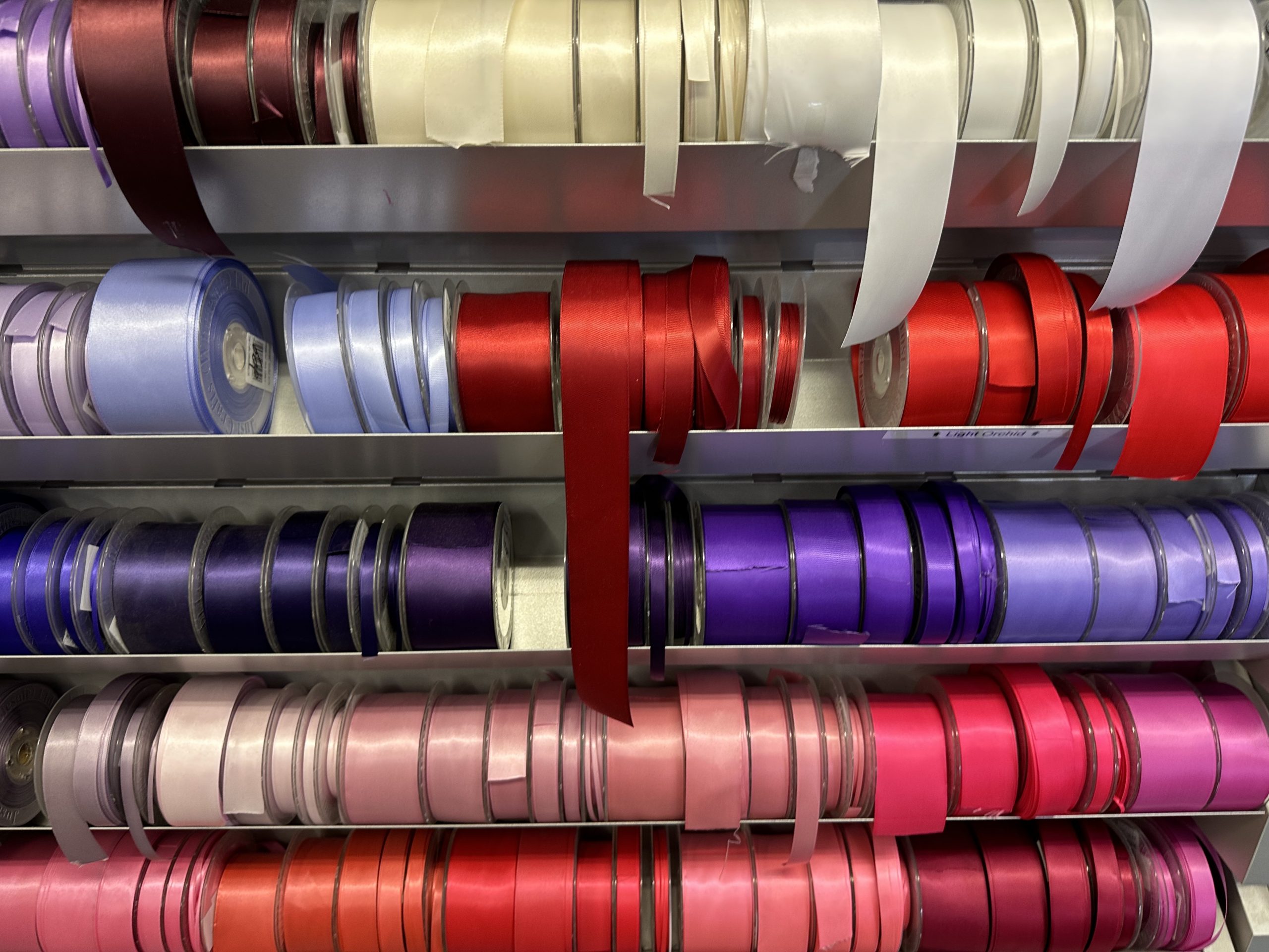 rolls of multicoloured ribbon at a fabric store