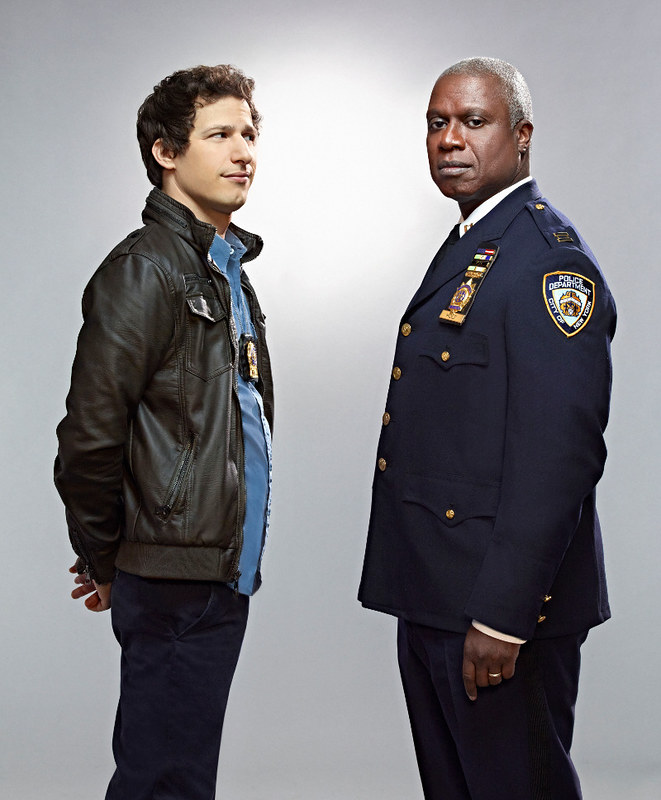 Jake Peralta and Captain Raymond Holt from Brooklyn Nine-Nine stand together.