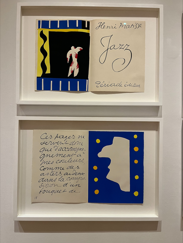Two artworks framed perpendicular to each other. Both are landsape papers with one half showing an abstract shape and the other half with writing.
