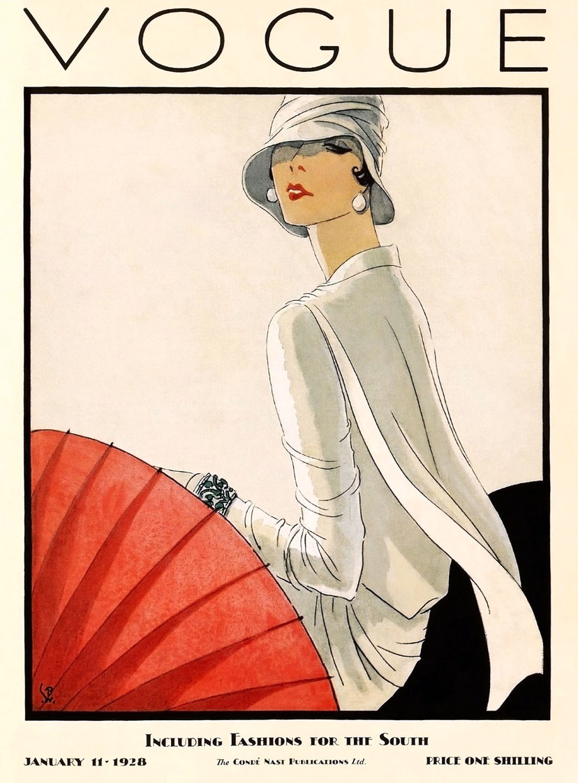 January 1929 cover of British Vogue, an illustrated woman dressed in white looks toward a red fan.