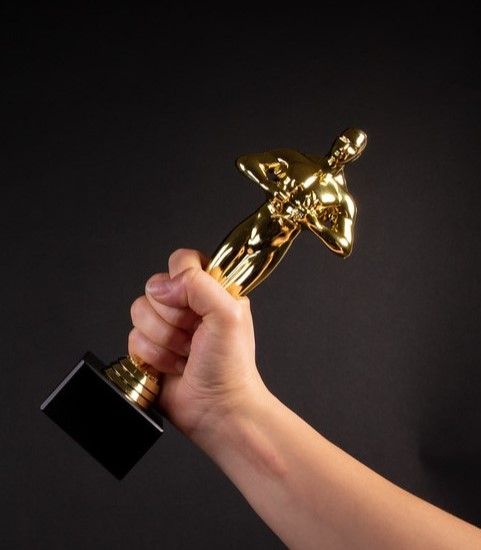 Hand clutching an Oscars statue